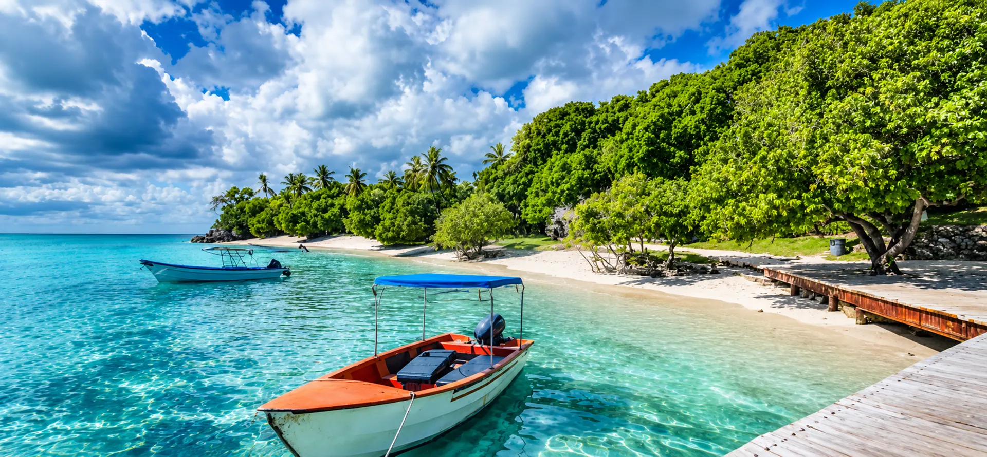 Local boats on turquoise water beside a wooden jetty on the Samaná coast