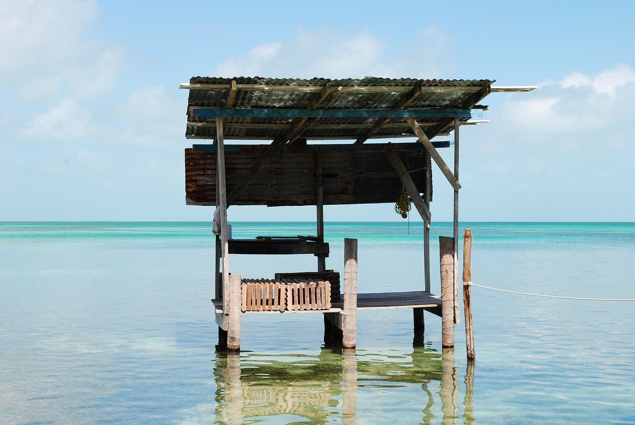Wooden hut standing over calm turquoise water