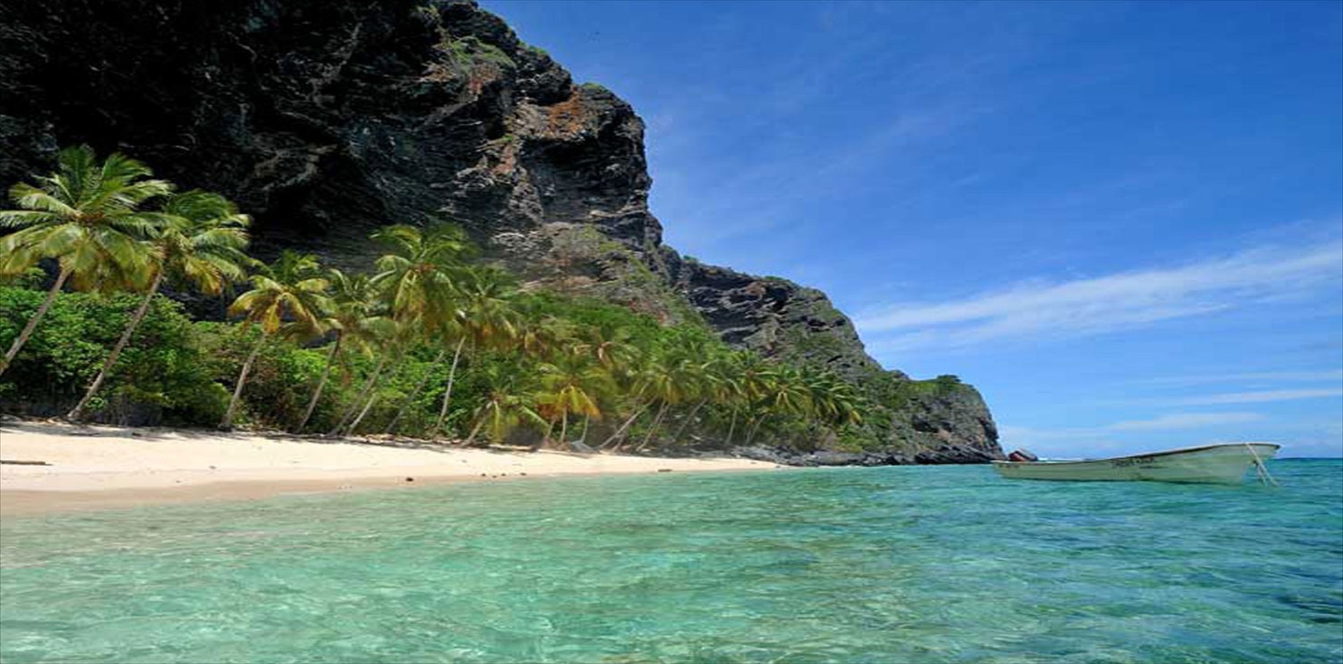 White sand beach below a limestone cliff on the Samaná peninsula