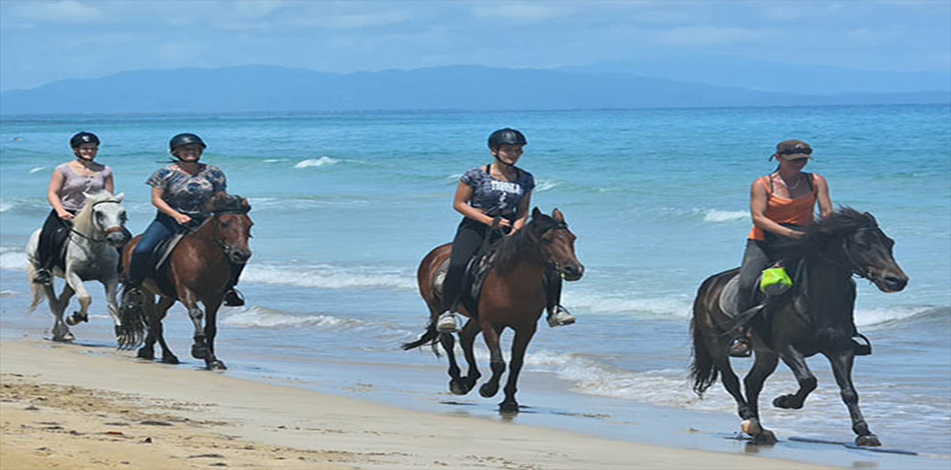 Riders on horseback along the shoreline near Las Terrenas