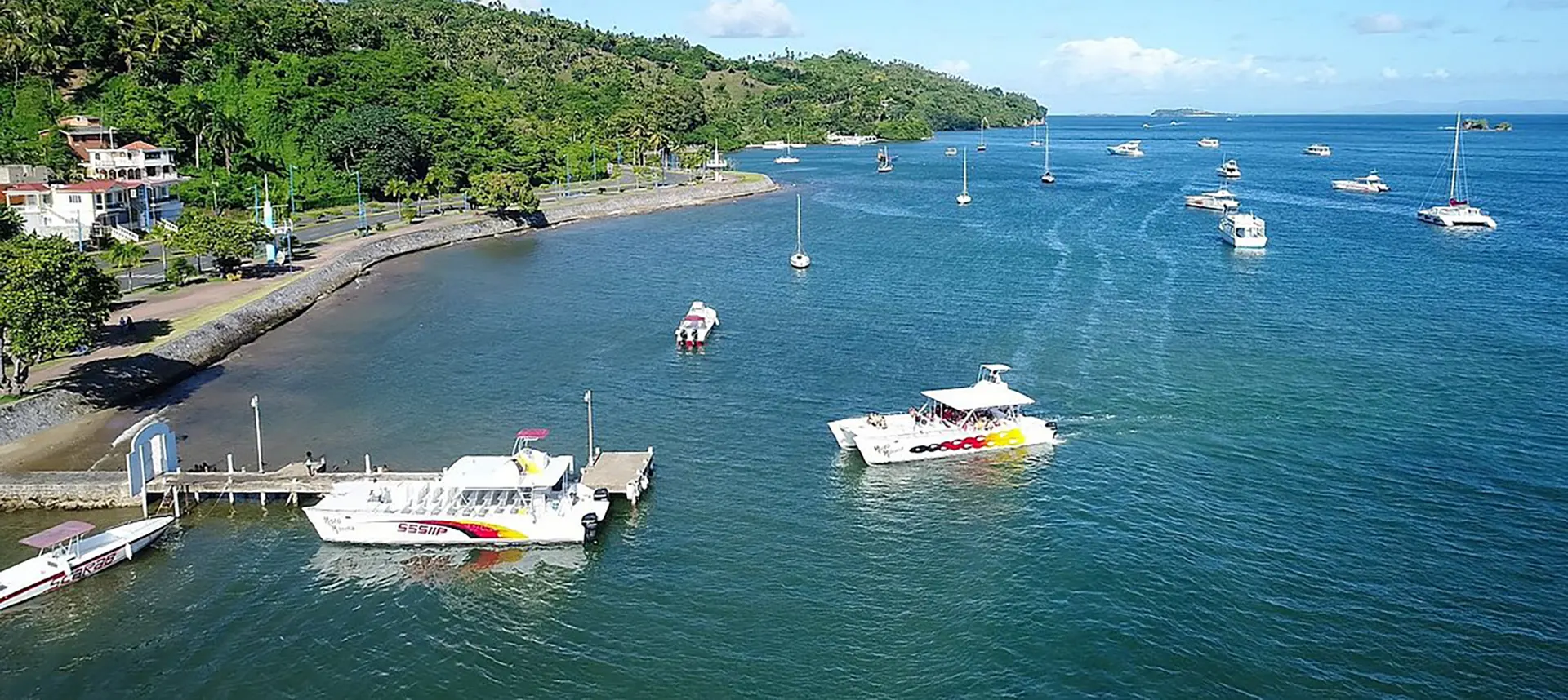 Boats moored in the calm water of Samaná bay